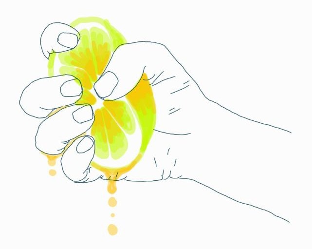 A hand squeezing a lemon half, juice dripping